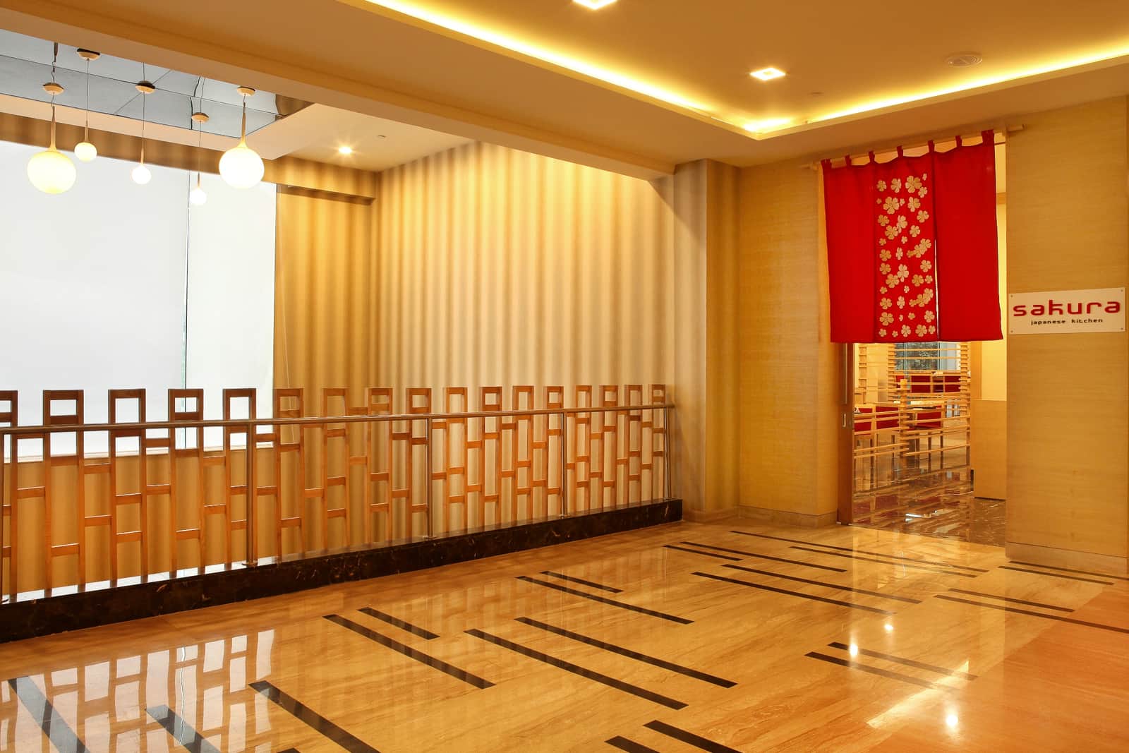 The approach to Sakura, its red noren curtain and name board at the end