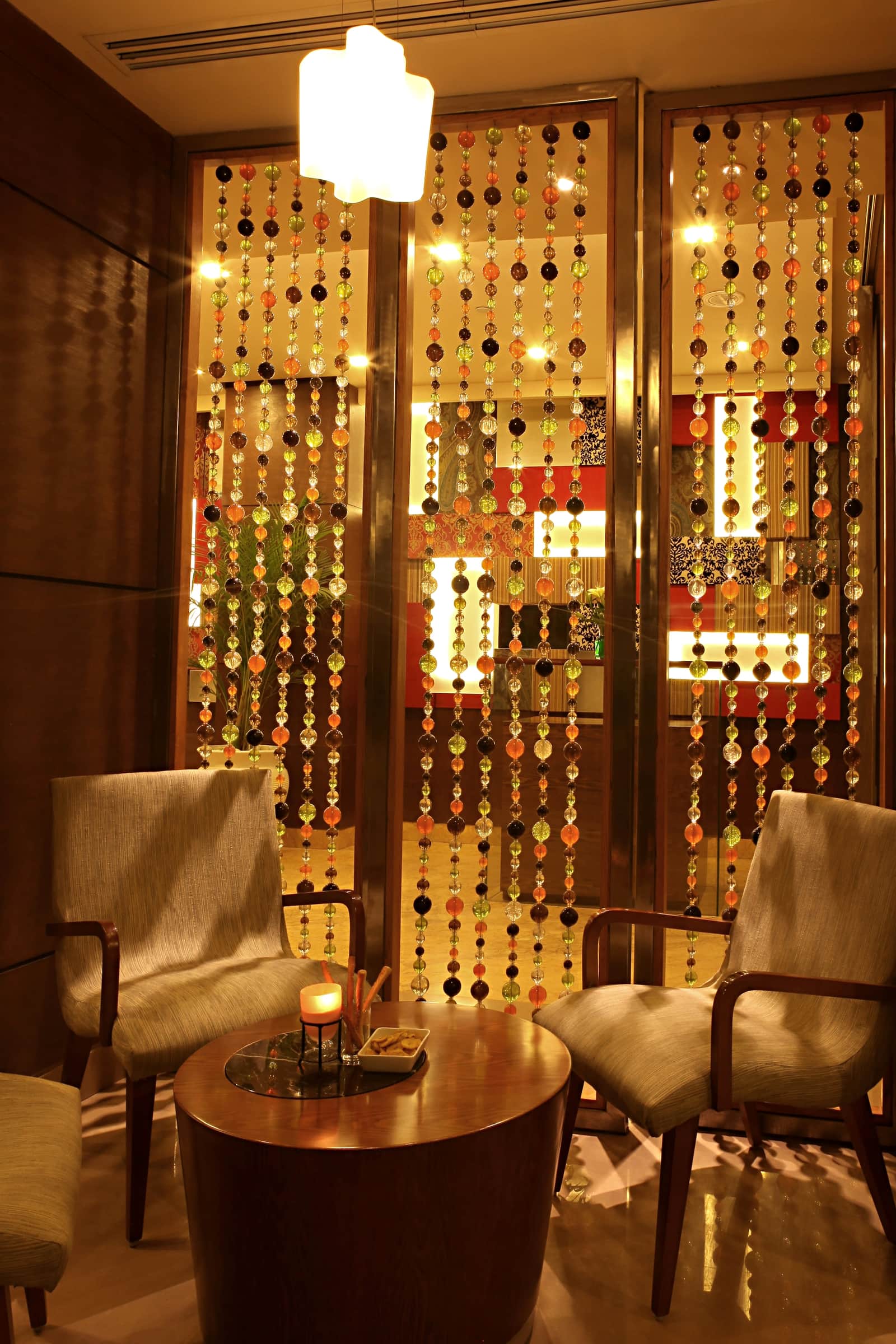 Armchairs beside the beaded screen at Chutney