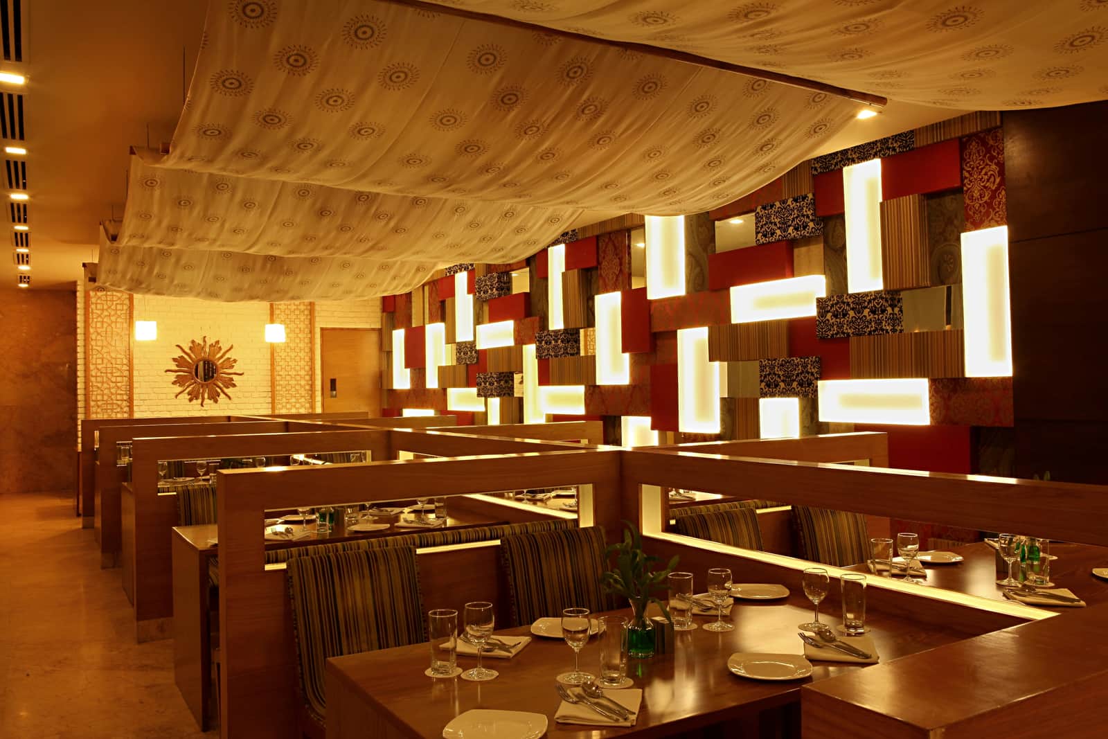 The dining room at Chutney, its backlit wall panels running the length of the room