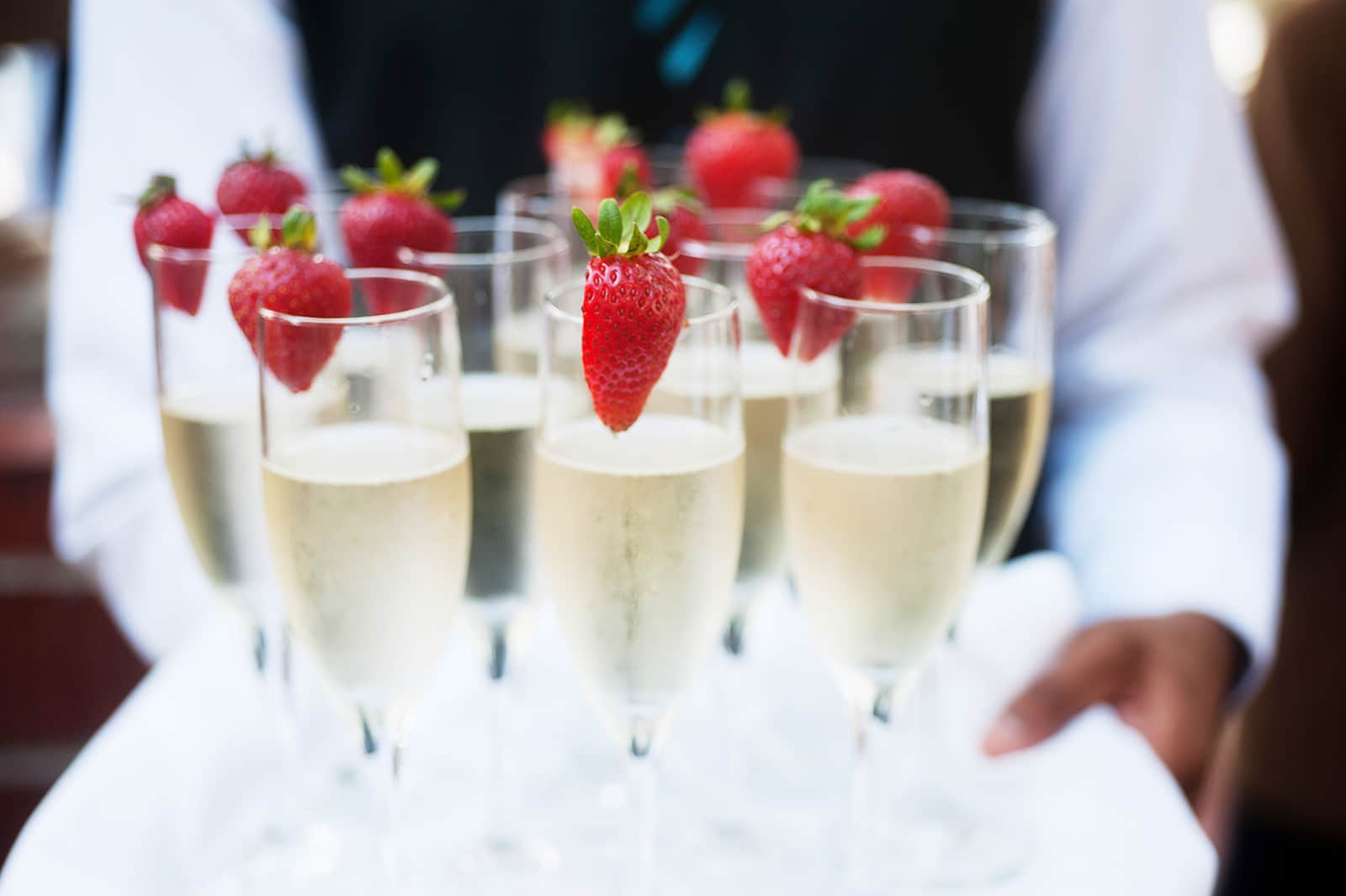 Glasses of champagne with strawberries, served at an event