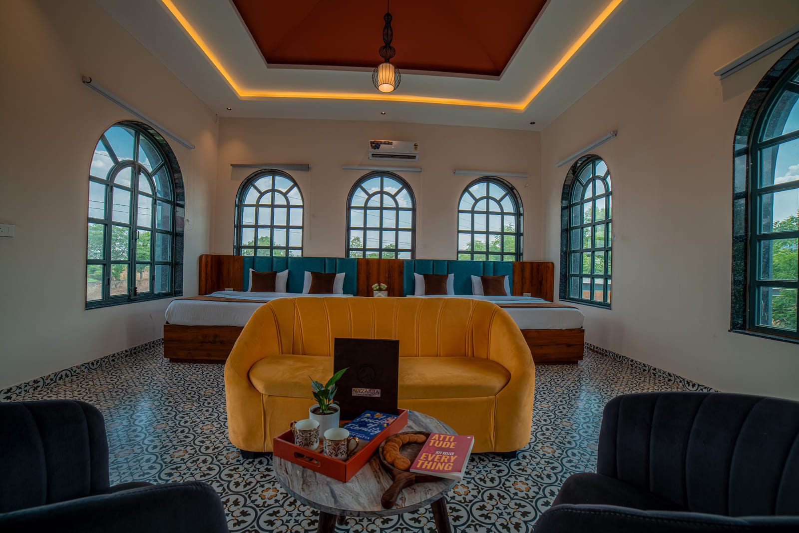 Nazaara Family Suite at Nazaara Hills Retreat, Udaipur, twin beds beside a lounge seating area