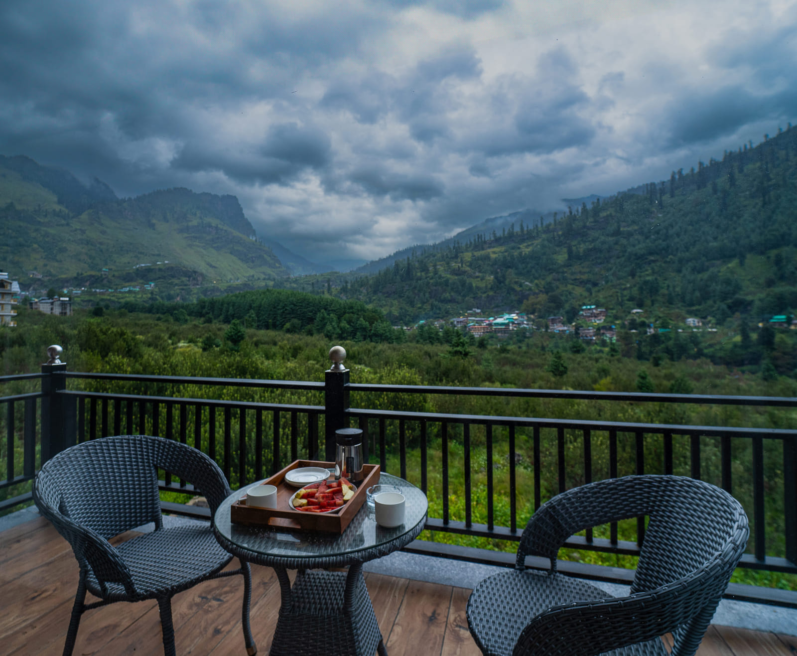 Private balcony of the Premium Room at Nazaara Luxe Retreat, open chairs facing a wide mountain view, Manali