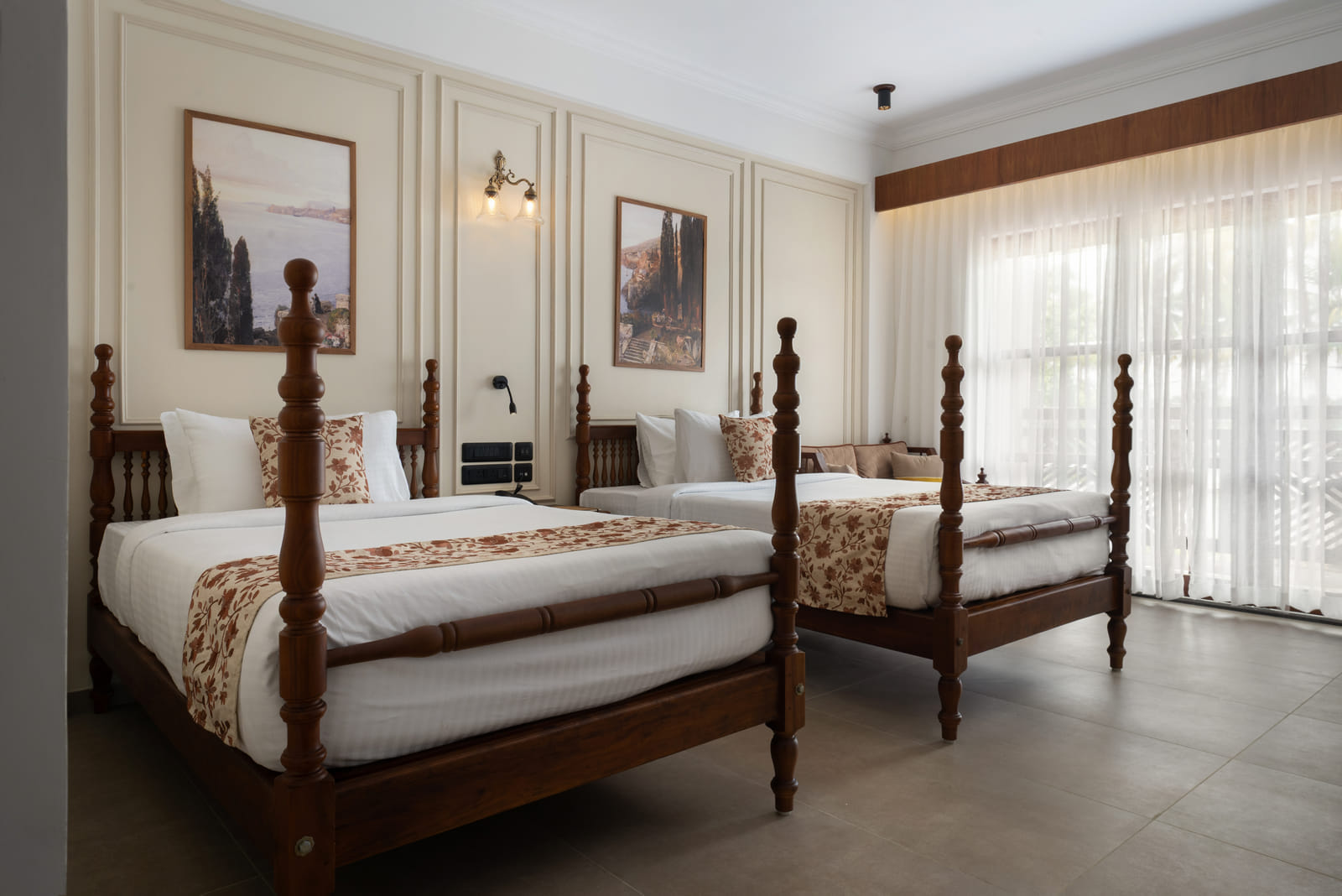 Twin beds and a green garden-facing balcony in the Garden View Room at Sanskreti, Kumbalanghi, Kochi