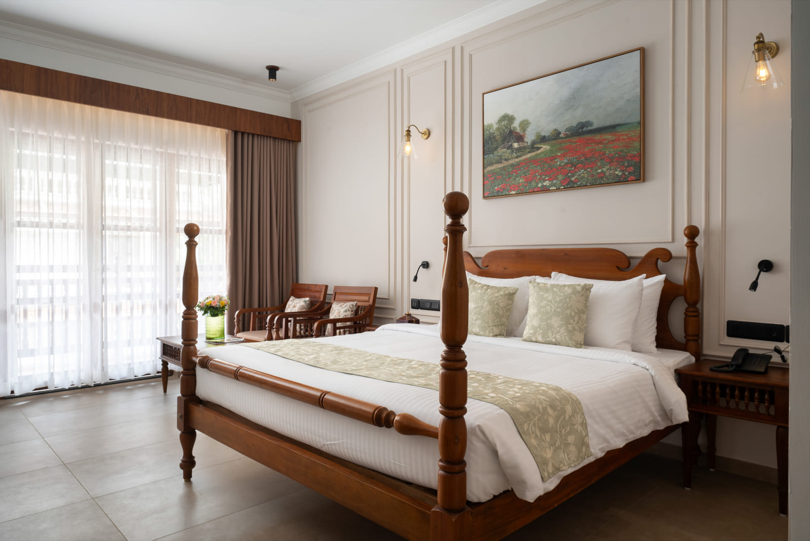 King bed with a private balcony over the infinity pool and partial lake view in the Pool View Room at Sanskreti, Kochi