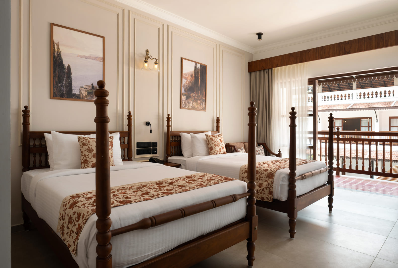 Twin beds with a private balcony over the infinity pool and partial lake view in the Pool View Twin Room at Sanskreti, Kochi