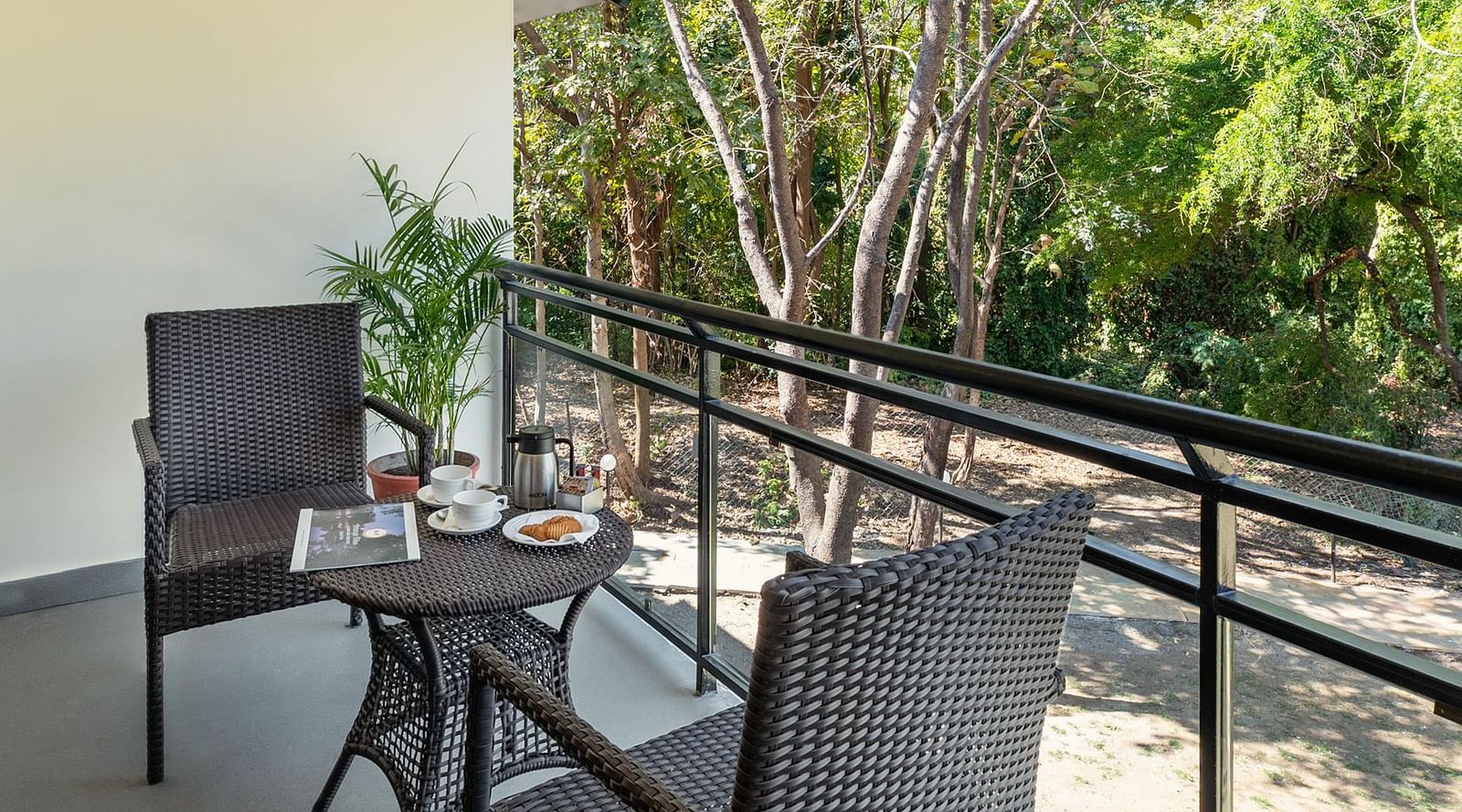 image of the sit out area at the luxury cottage room at the aranya vilas with  a lush  green scenery 