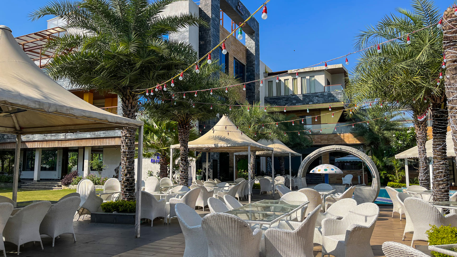 Miraya Dining, Flamingo poolside tables beneath the festoon lights