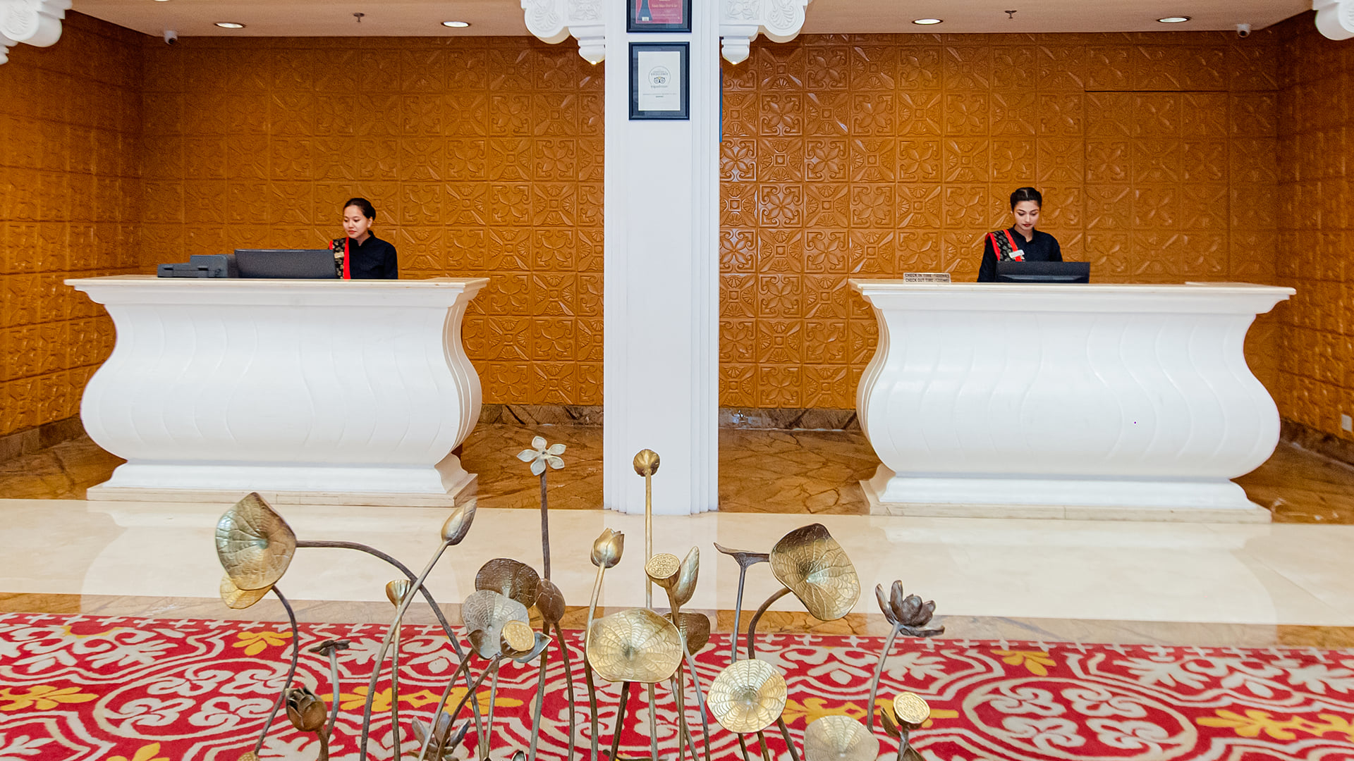 The reception desks in the lobby of Ramada by Wyndham Udaipur Resort and Spa