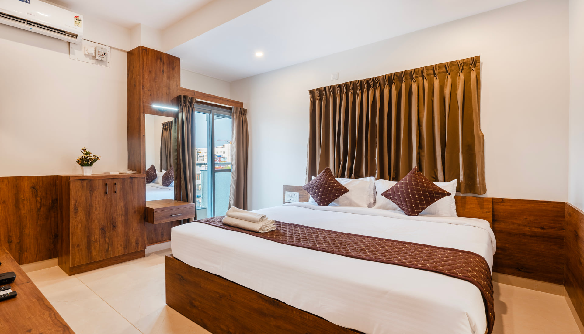 Executive Room with a queen bed and balcony window