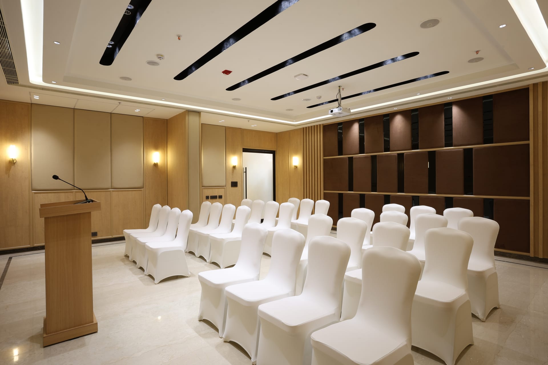 Apex meeting room laid out theatre style with a projector screen at Triumph Regency OMR Chennai