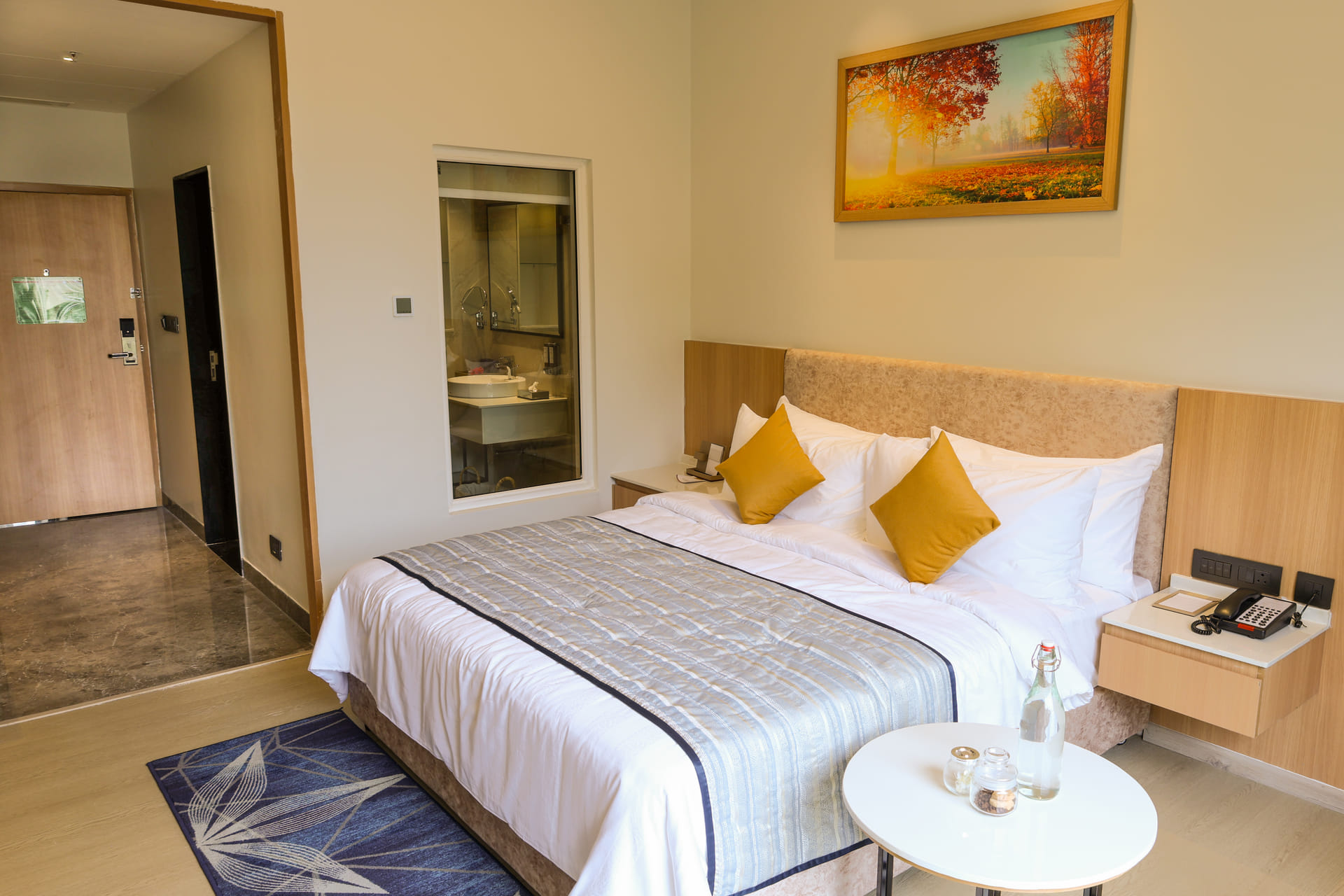 Spacious Triumph Club King room with a king bed and seating at Triumph Regency OMR Chennai