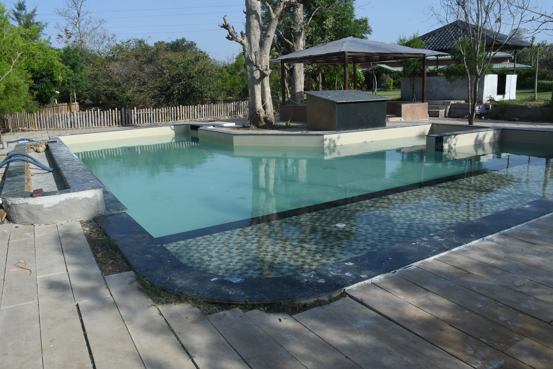 Resort pool ringed by sal and teak