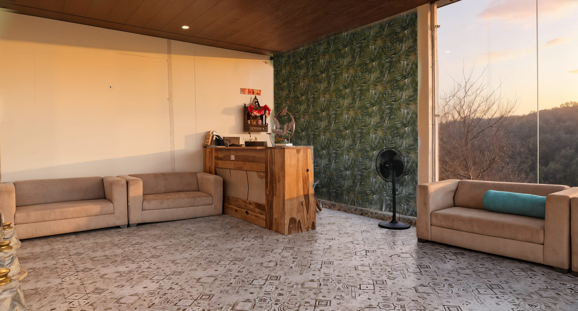 Wooden reception desk beside cushioned lounge seating at Nazaara Nature Retreat, softly lit for guests checking in