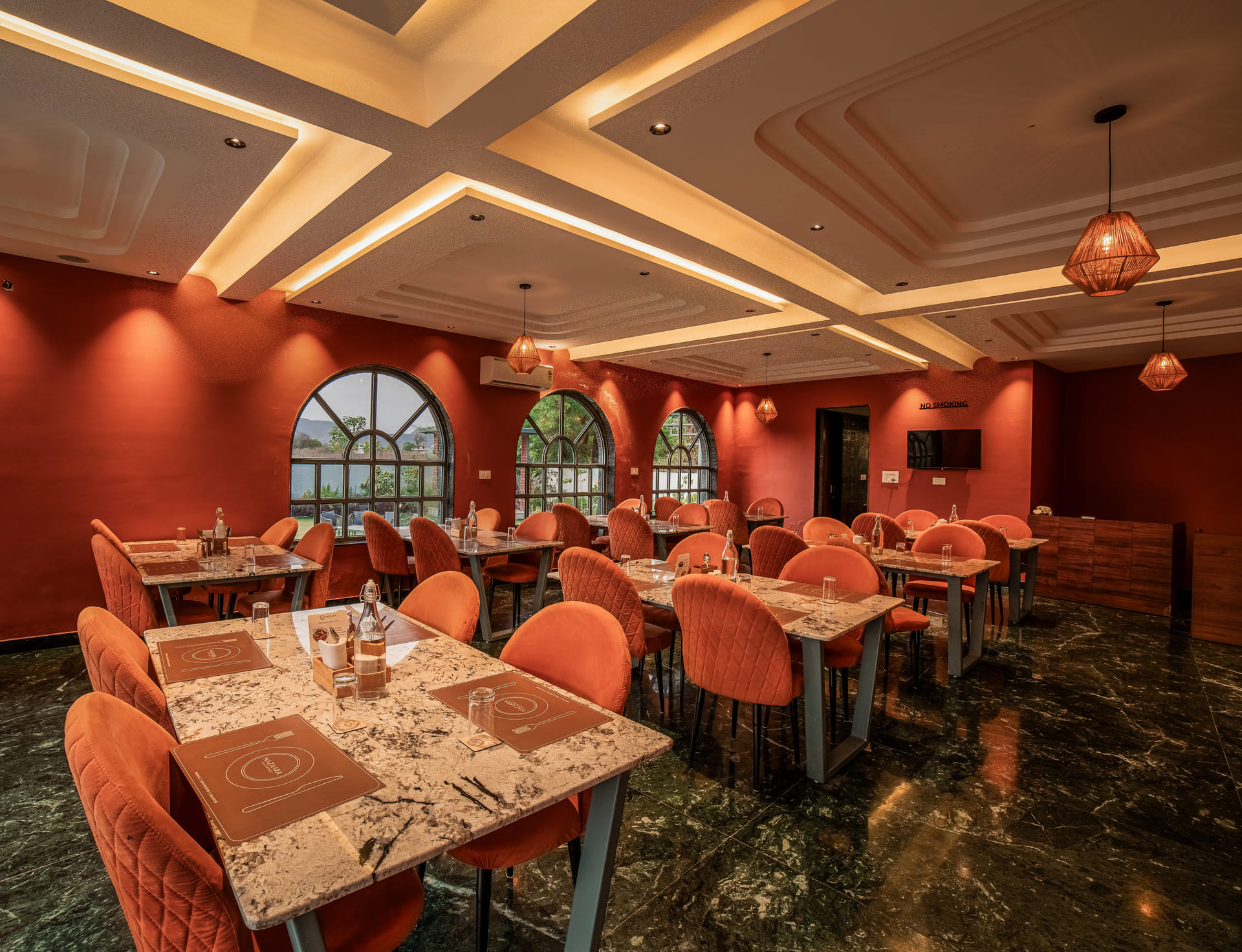 Interior seating at Nazaara Fine Dine restaurant, Nazaara Hills Retreat, Udaipur, arranged for indoor dining