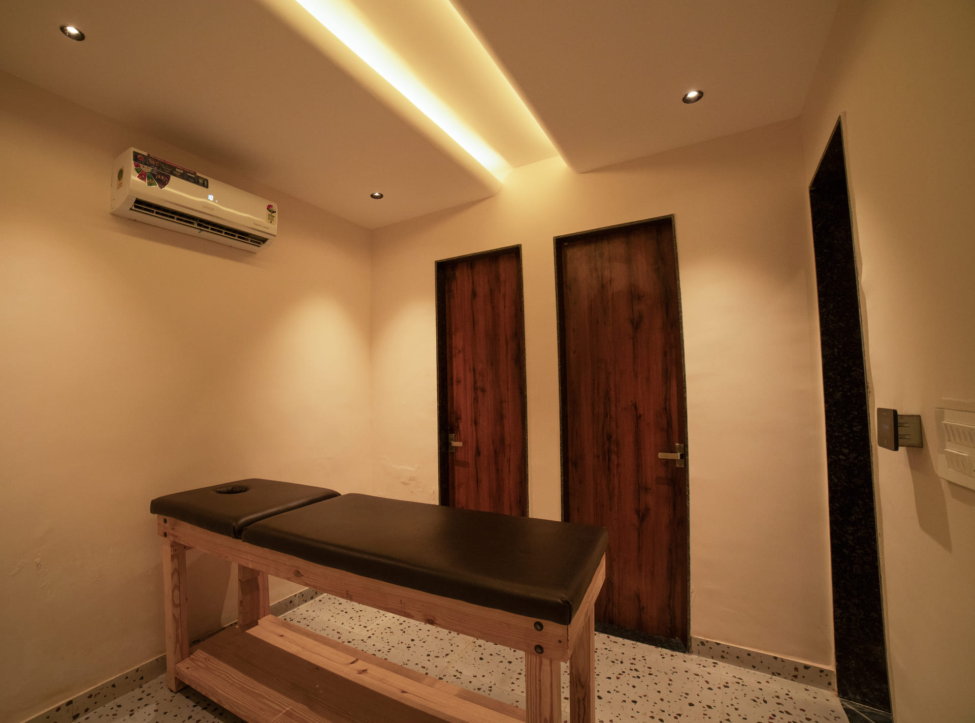 A massage table set up beside a jacuzzi tub in a suite at Nazaara Hills Retreat, Udaipur