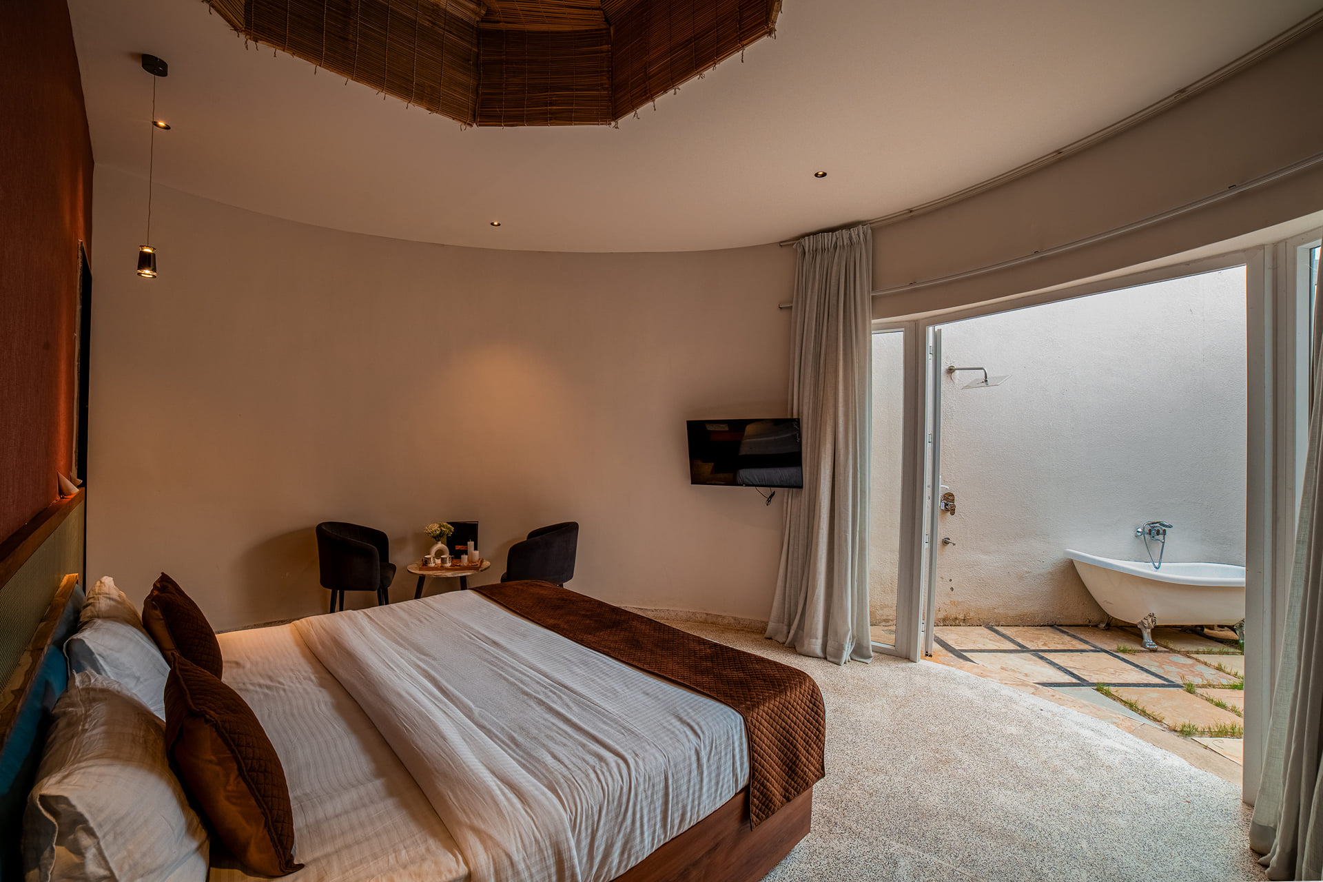 Luxurious Cabana Cottage bedroom opening onto its private patio and outdoor tub, Udaipur