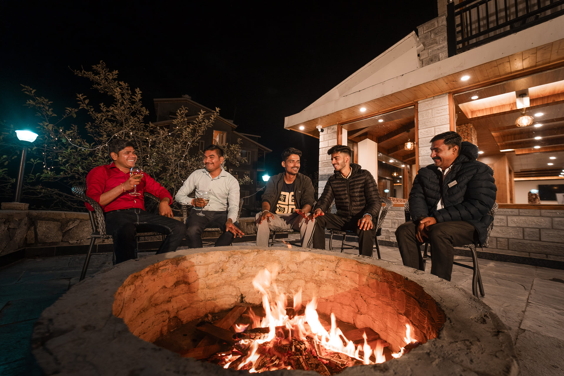 Guests gathered around the evening bonfire at Nazaara Luxe Retreat, Manali