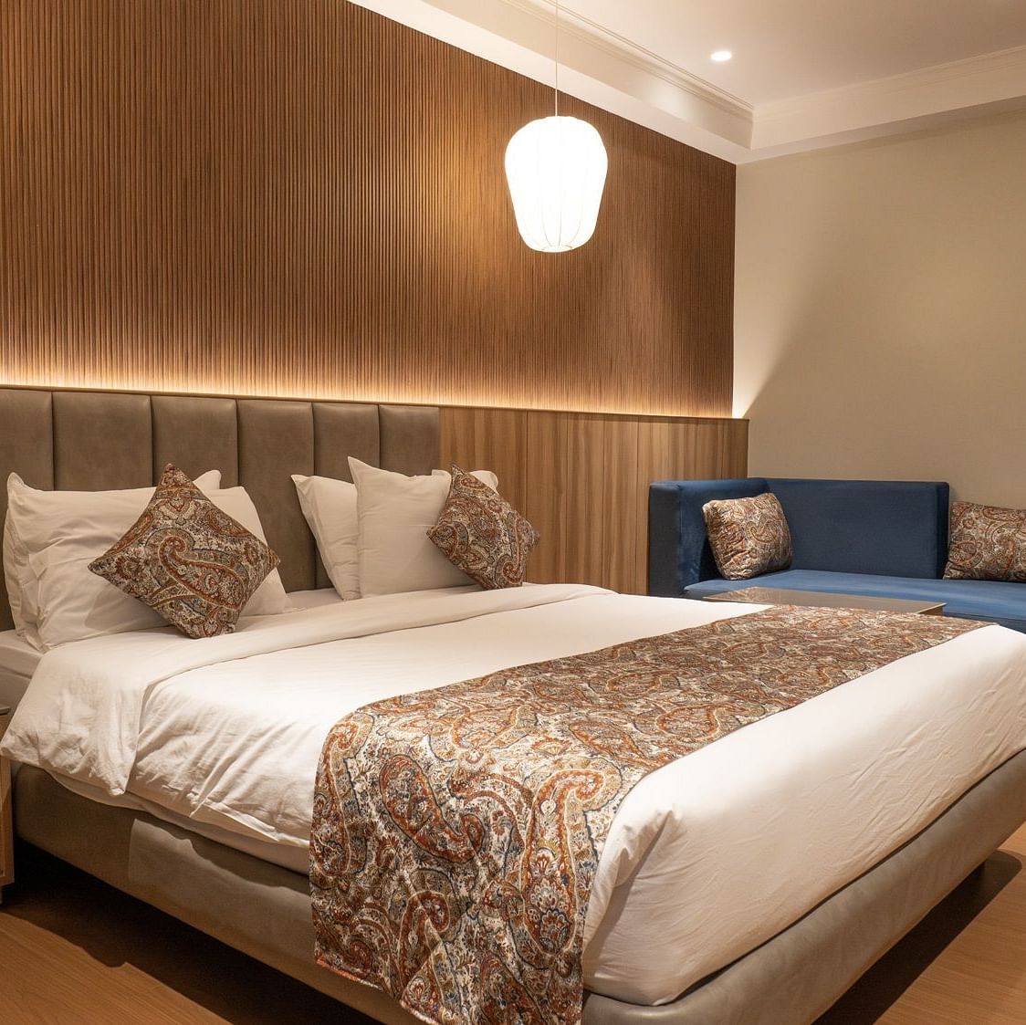 side view of the double bed inside super deluxe room - The Cindrella Hotel, Siliguri