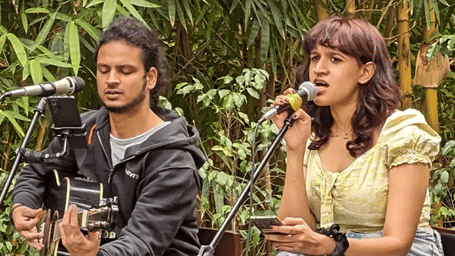 Guests enjoying outdoor dining surrounded by lush greenery at Karma Chalets.