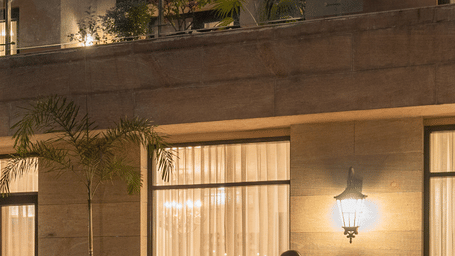 An elegant outdoor dining space at dusk, with guests enjoying food and conversations at Krama Chalets.