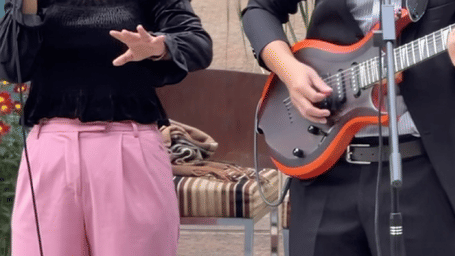 A live music duo performing at an outdoor seating area, creating a warm and lively ambience at Krama Chalets.