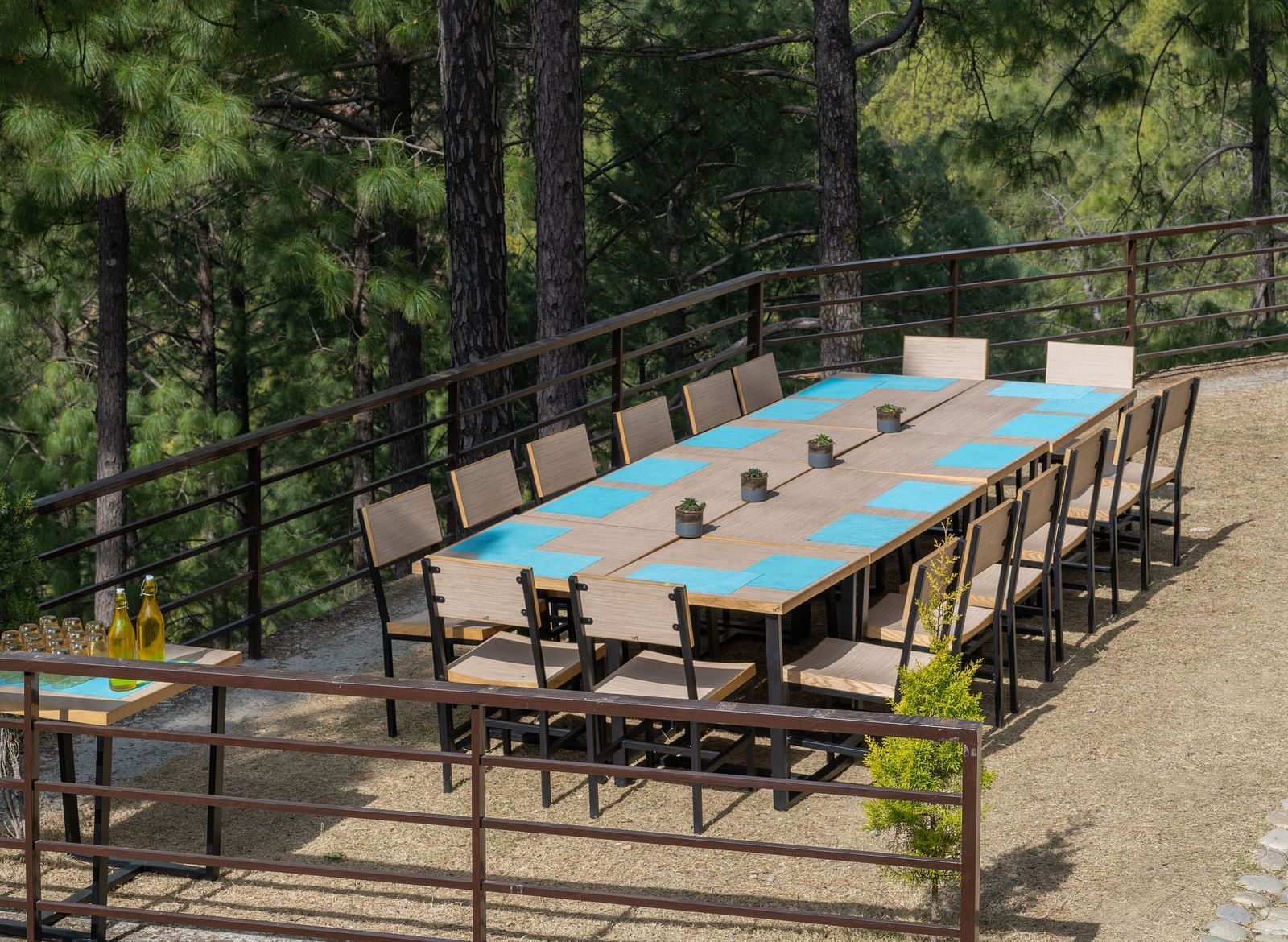 Lawn with neatly arranged chairs and a long table set up for an event at BluSalzz Escapade Resort, Lansdowne