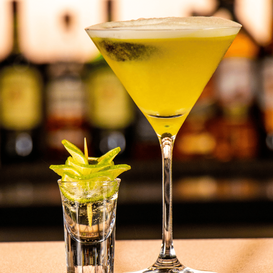 Cocktail glass and shot glass placed on a bar counter at Asiatic Rooftop Bar and Restaurant.