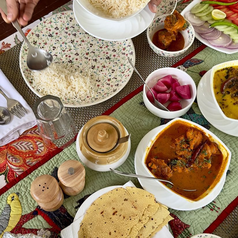 image of a dining table with various dished plated and kept on it