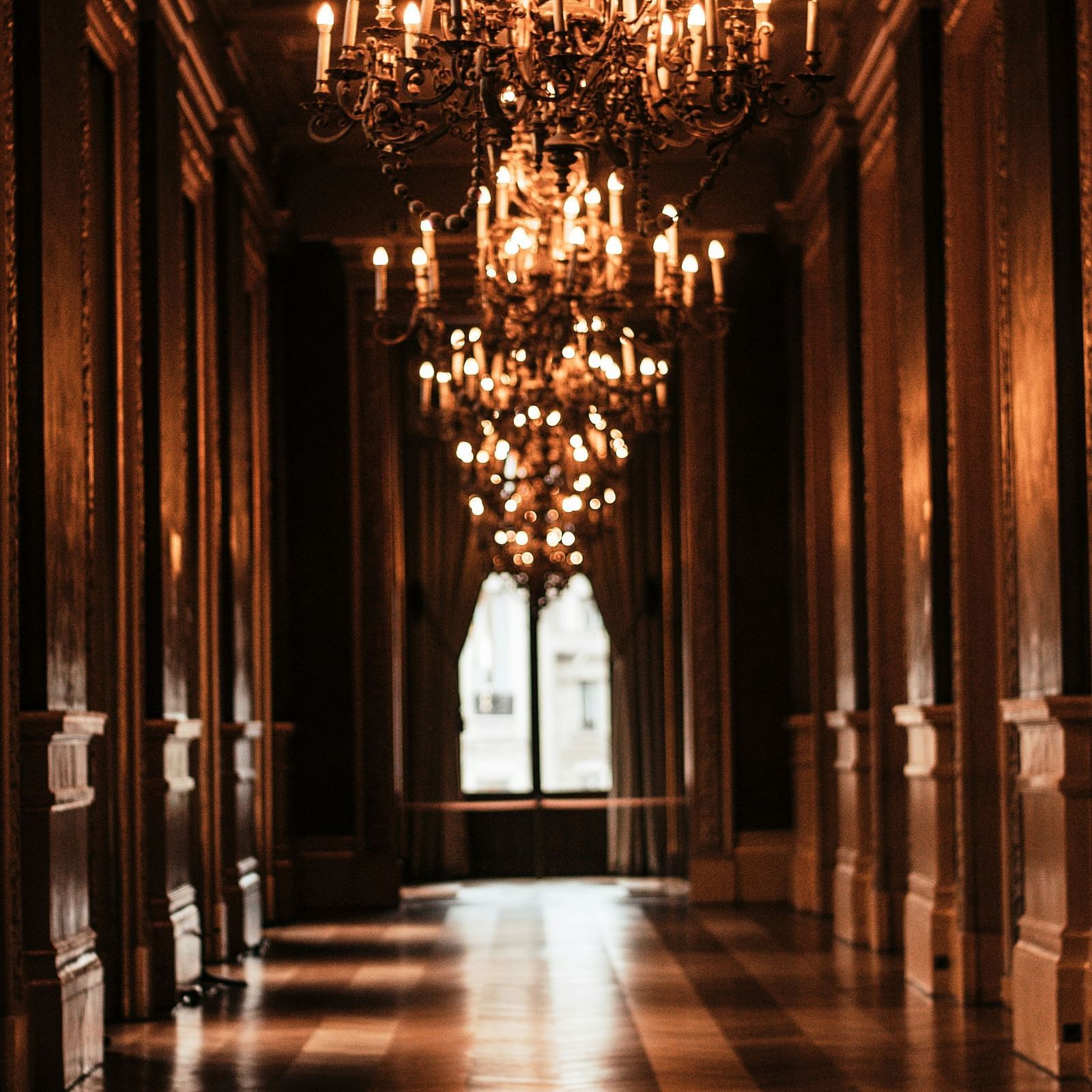 An elegant corridor illuminated by chandelier lights
