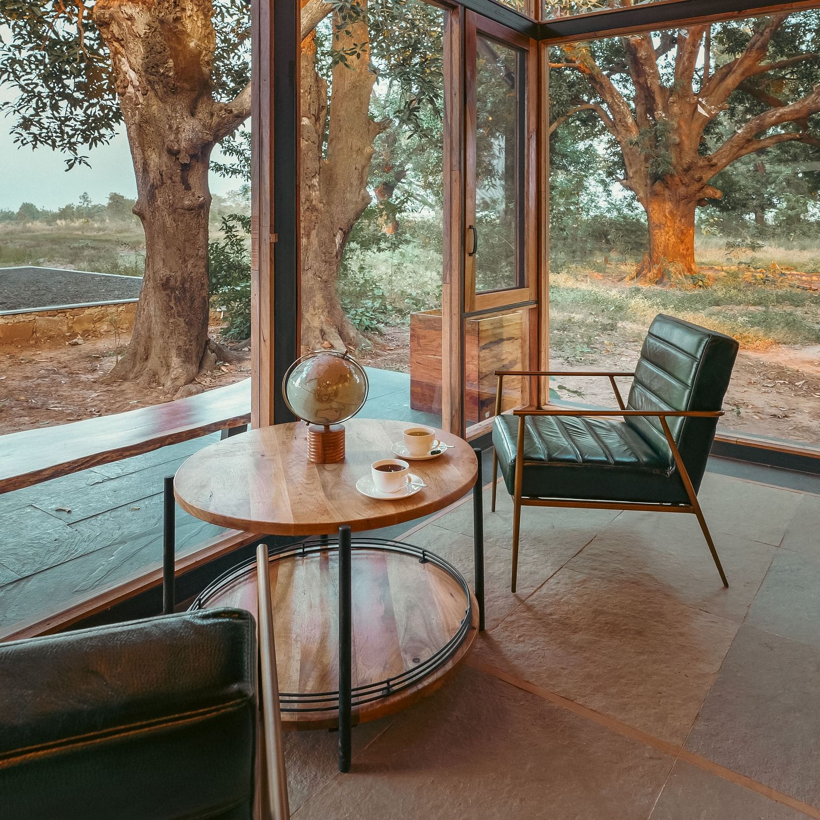 A side view of the corner spot of the dining area with table and chair at Trees N Tigers, Tadoba.