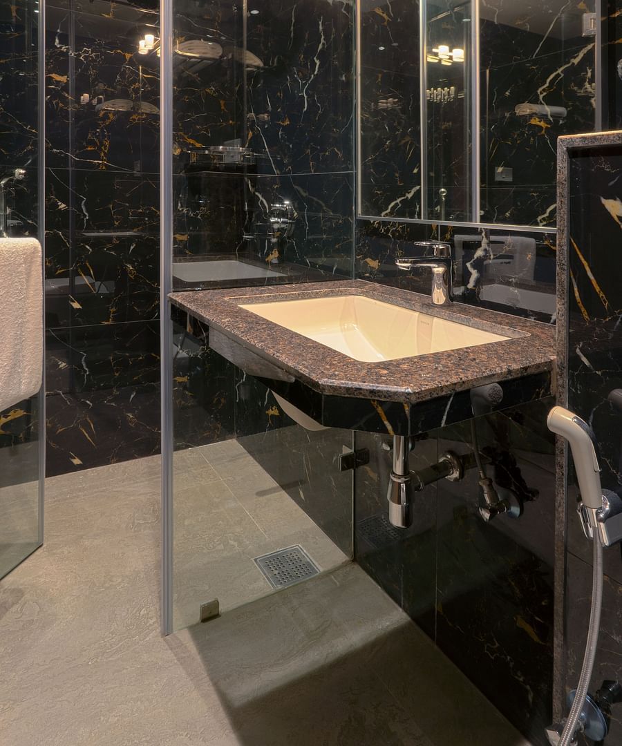 An overview of the shower area inside the bathroom of Deluxe Suite - Magnus Nexstar Suites, Pune