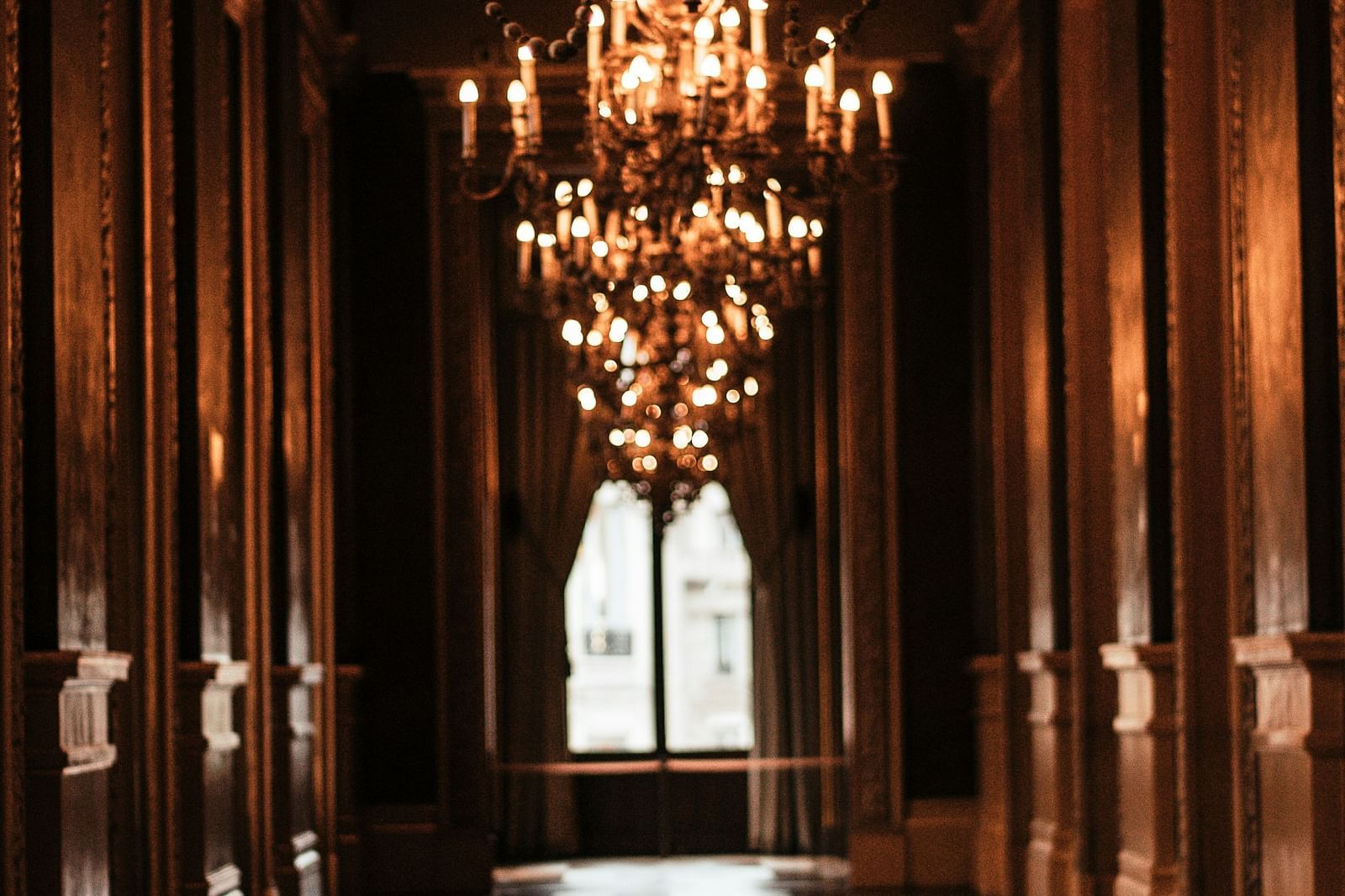 An elegant corridor illuminated by chandelier lights