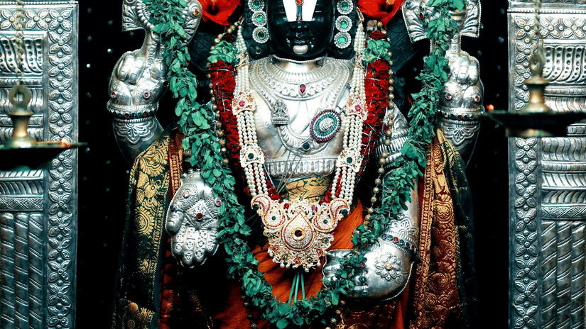 A detailed, colourful statue of Lord Venkateshwara in a temple.