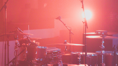 drums and amplifiers on a stage