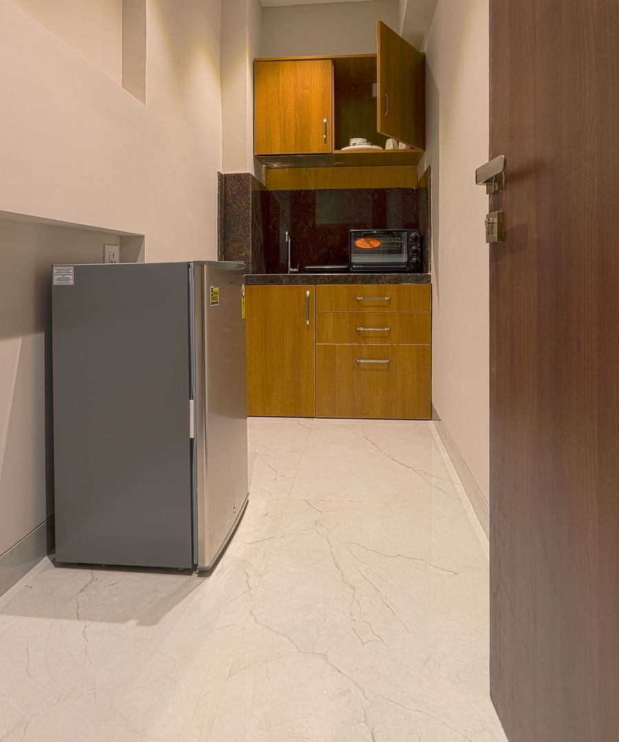 An overview of a kitchenette inside Deluxe Suites at Magnus Nexstar Suites, Pune