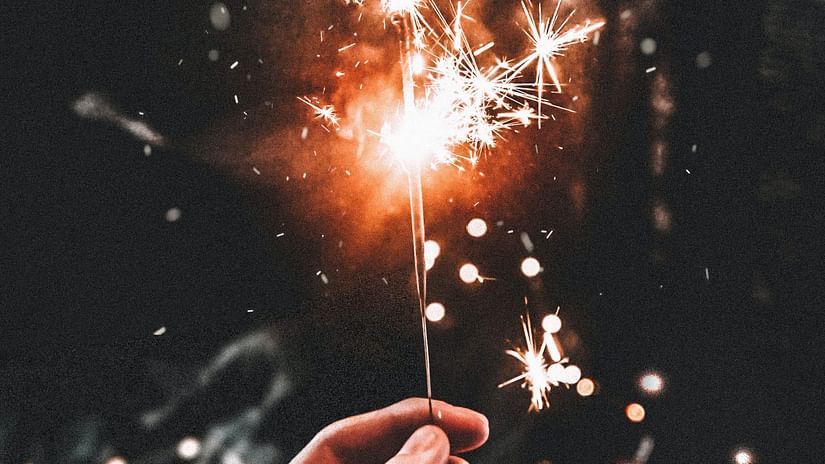 A person holding a sparkler on diwali