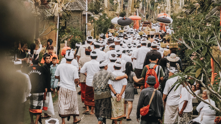 many people gathered at a tibal-rural festivity wearing their traditional attire.