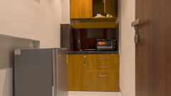 An overview of a kitchenette inside Deluxe Suites at Magnus Nexstar Suites, Pune