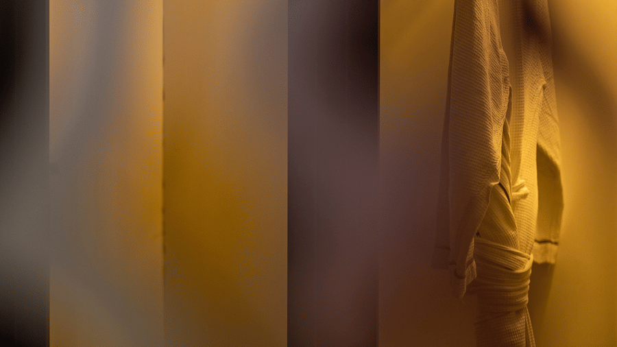 A close-up of a patterned room divider with soft lighting casting shadows, creating an intimate and stylish atmosphere within the room.