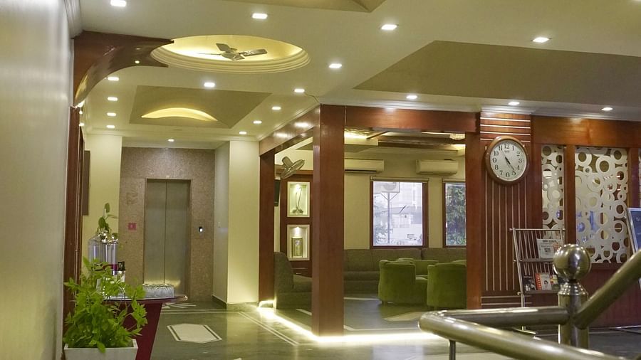 Entrance area at DLS Park Grace, Haridwar featuring the lift, warm lighting, and marble flooring.