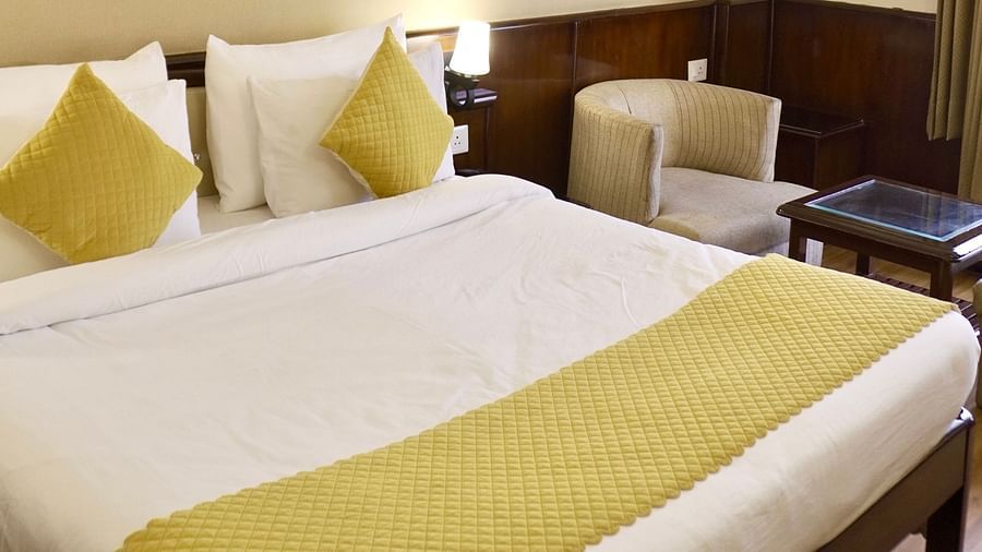 A bedroom with pillows neatly placed on the bed at DLS Park Grace, Haridwar.