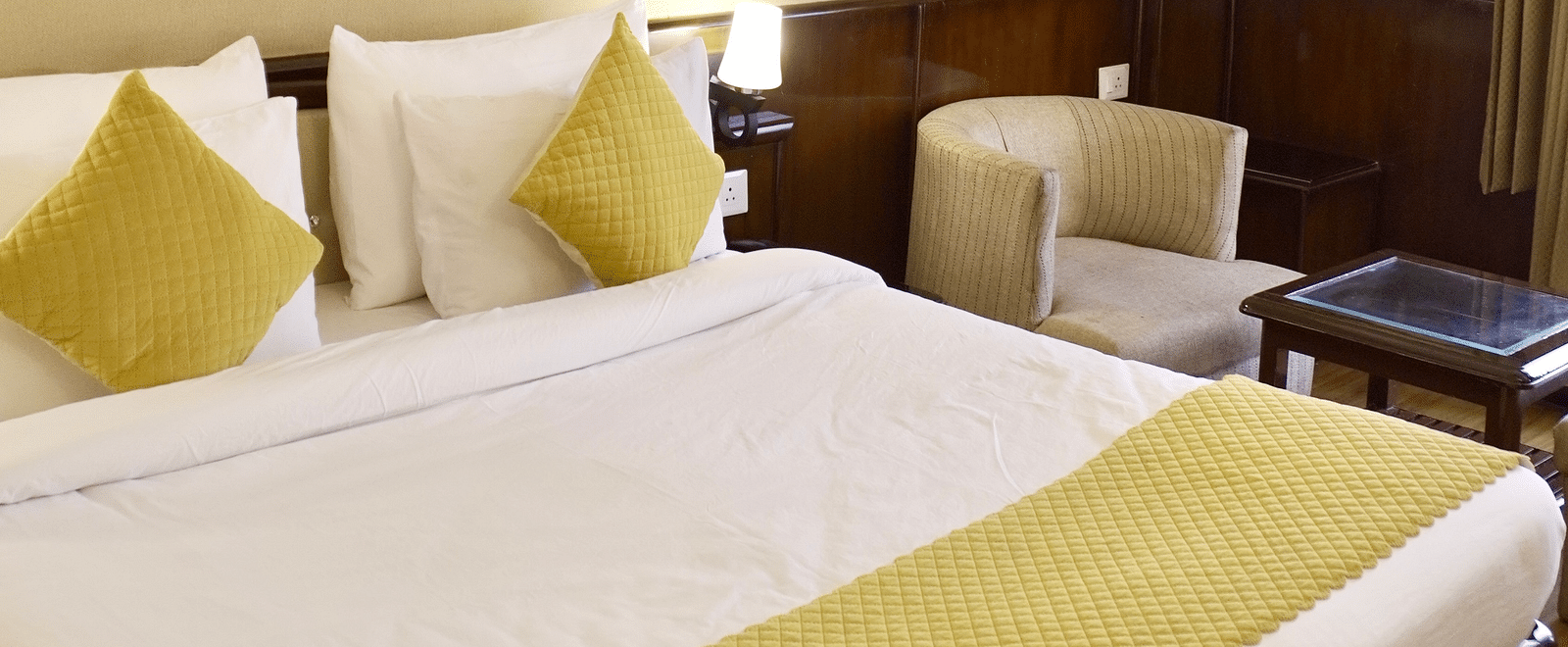 A bedroom with pillows neatly placed on the bed at DLS Park Grace, Haridwar.