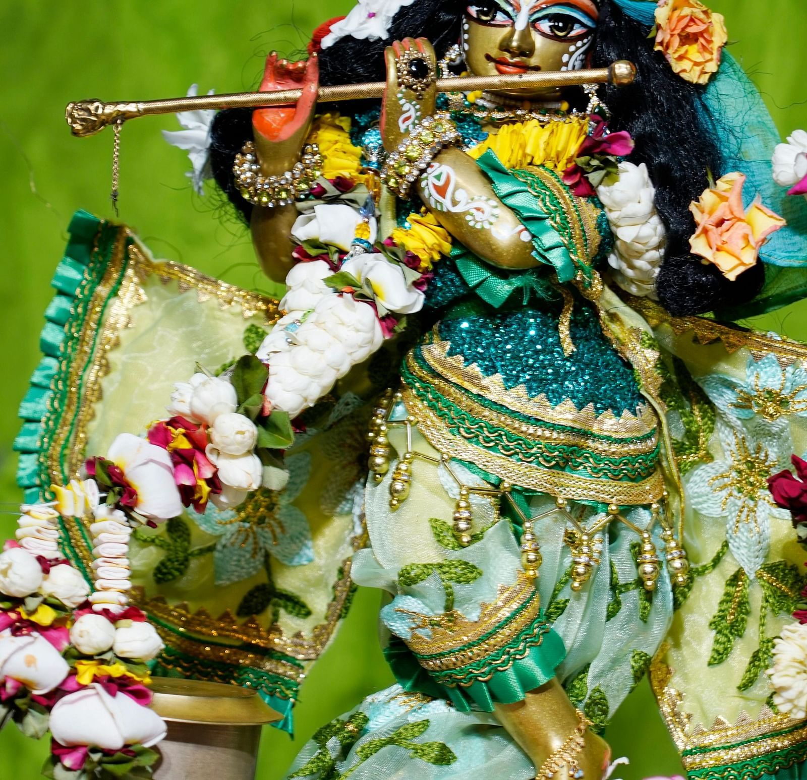 Krishna idol adorned with flowers.