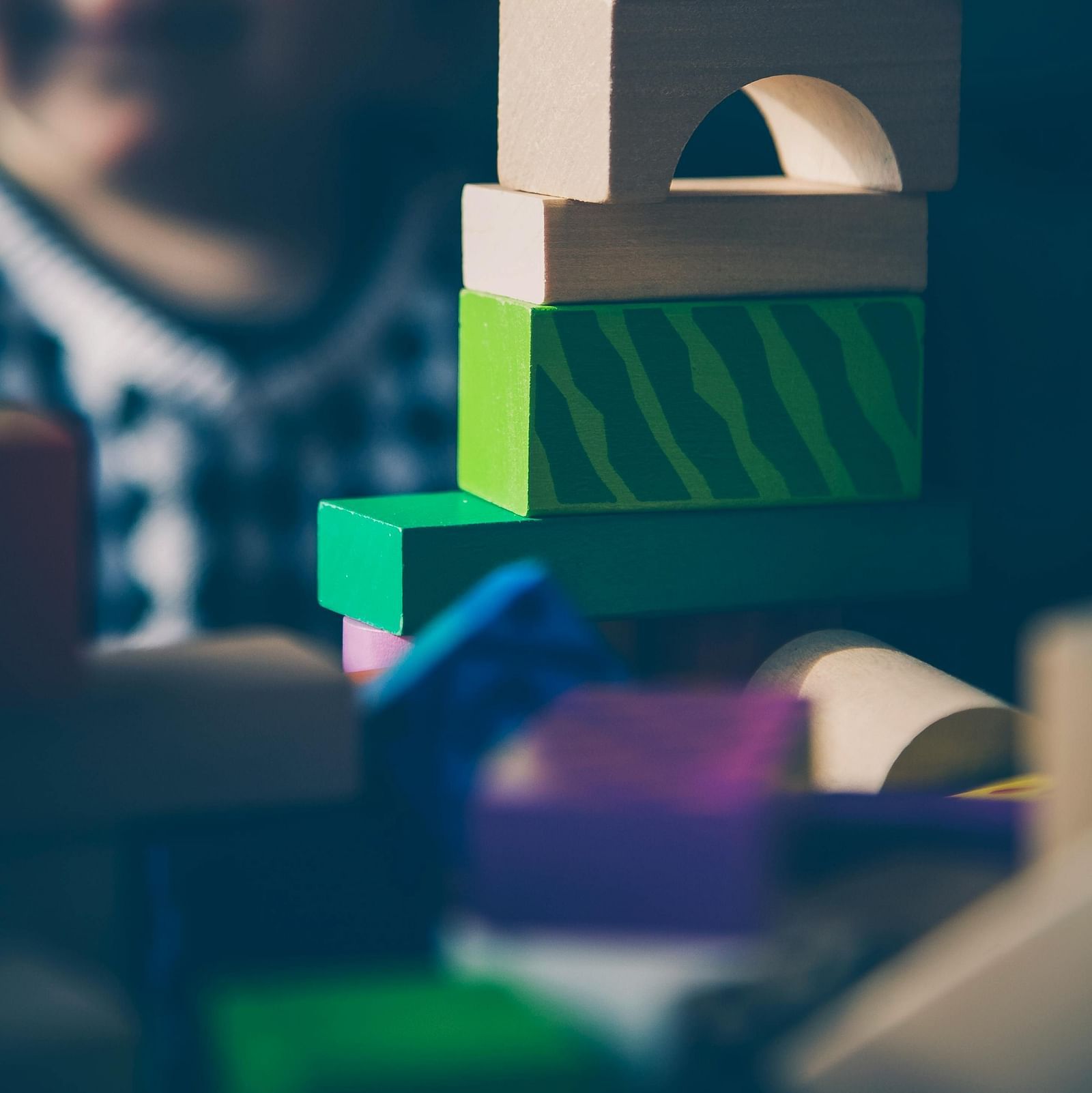 image of a toddler stacking up building blocks