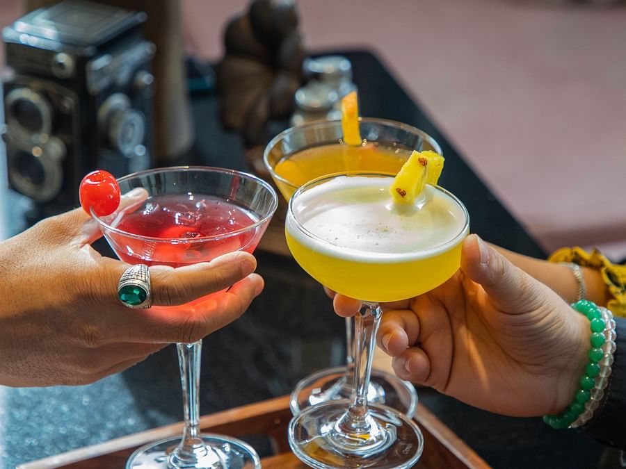 Colourful cocktails served on a wooden table.