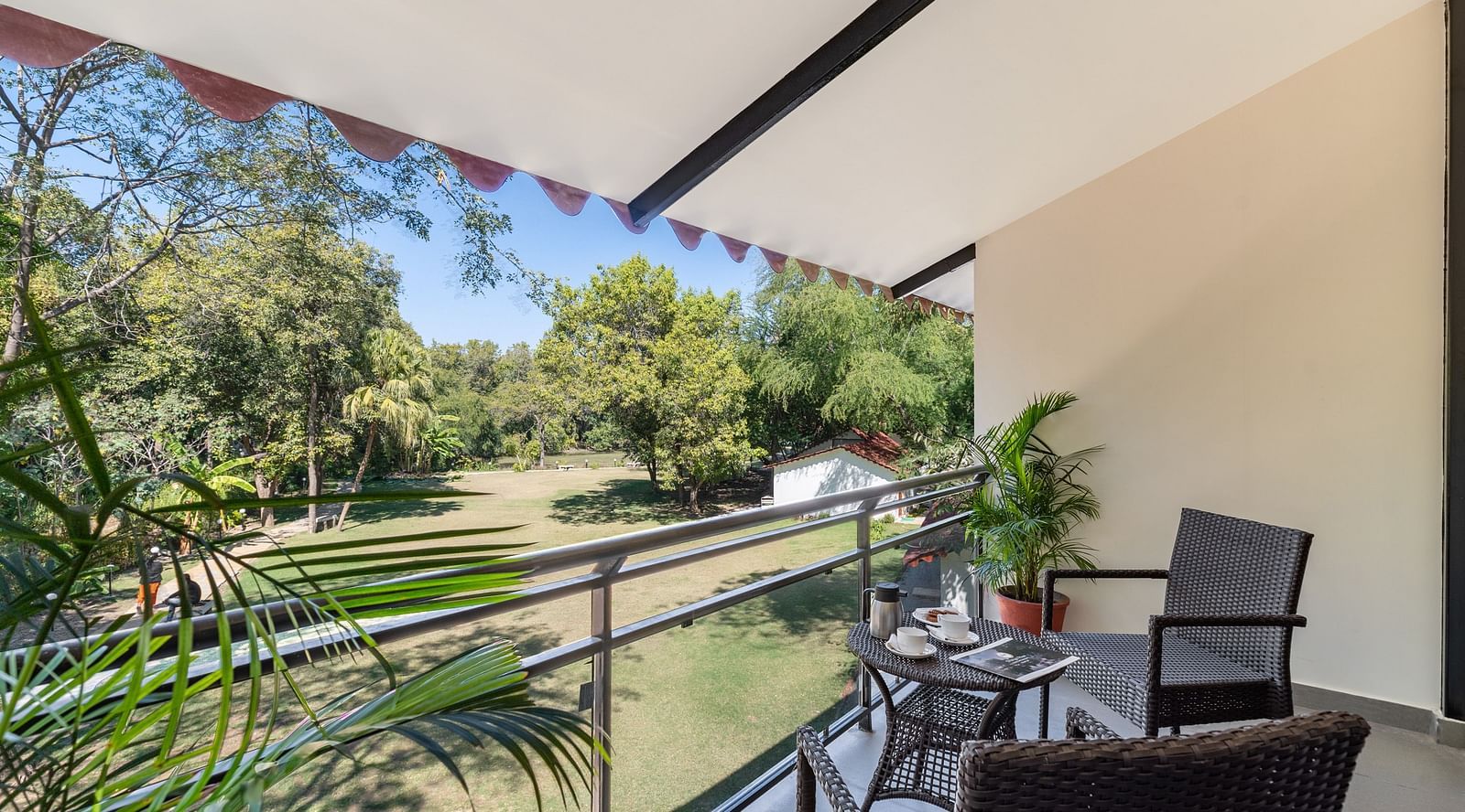 image of an amazing lush green view from the balcony of the luxury cotage room with a sit out area at aranya vilas