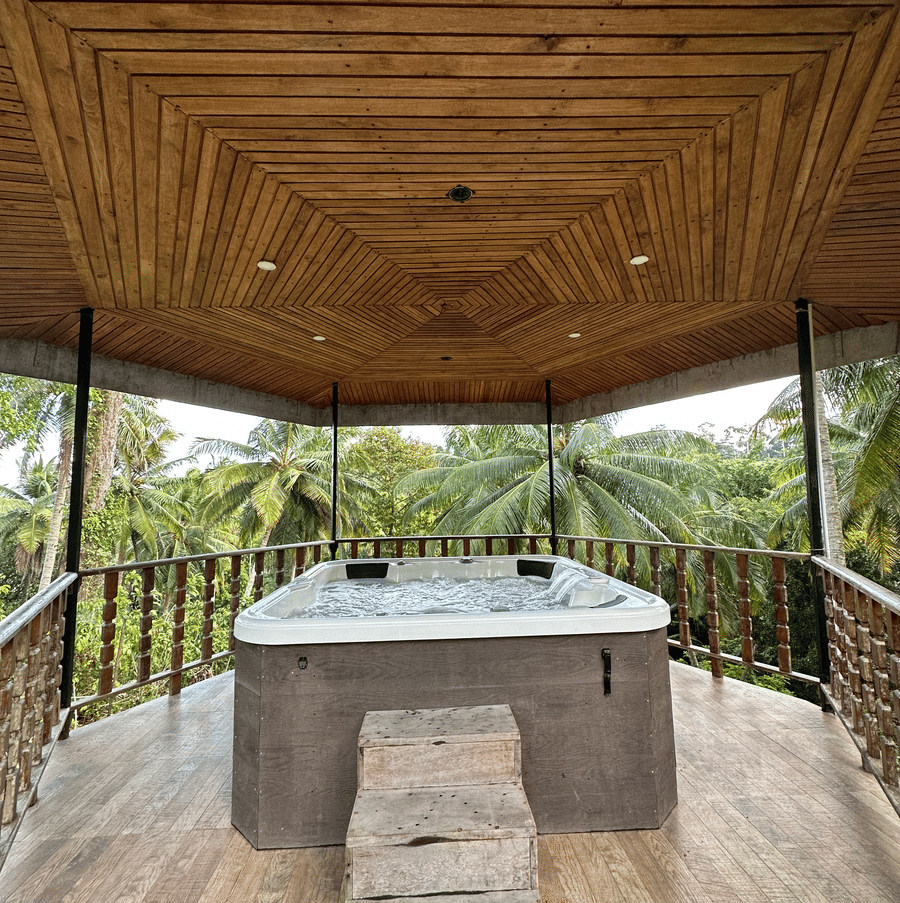 A hot tub Jacuzzi inside a covered wooden gazebo surrounded by tropical forest at Rainforest Jungle Resort, Port Blair, Andaman and Nicobar Islands.