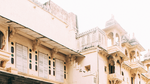 a woman wearing a red dress twirling at a fort