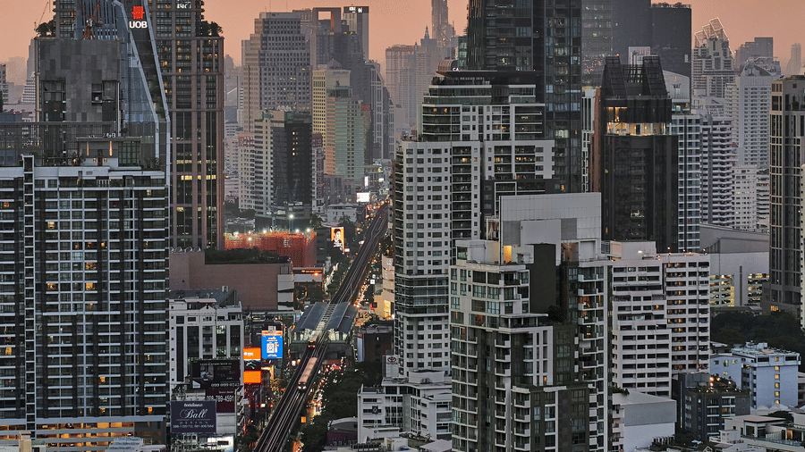 An aerial view of the Sol Sukhumvit 11 Area with high rise buildings, a metro line with a train on it as seen during twilight hour. Sukhumvit is the best part of Bangkok to stay on your holiday due to its central location.