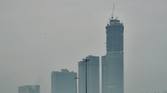 An overview of the city of Noida with skyscrapers and a highway in view.